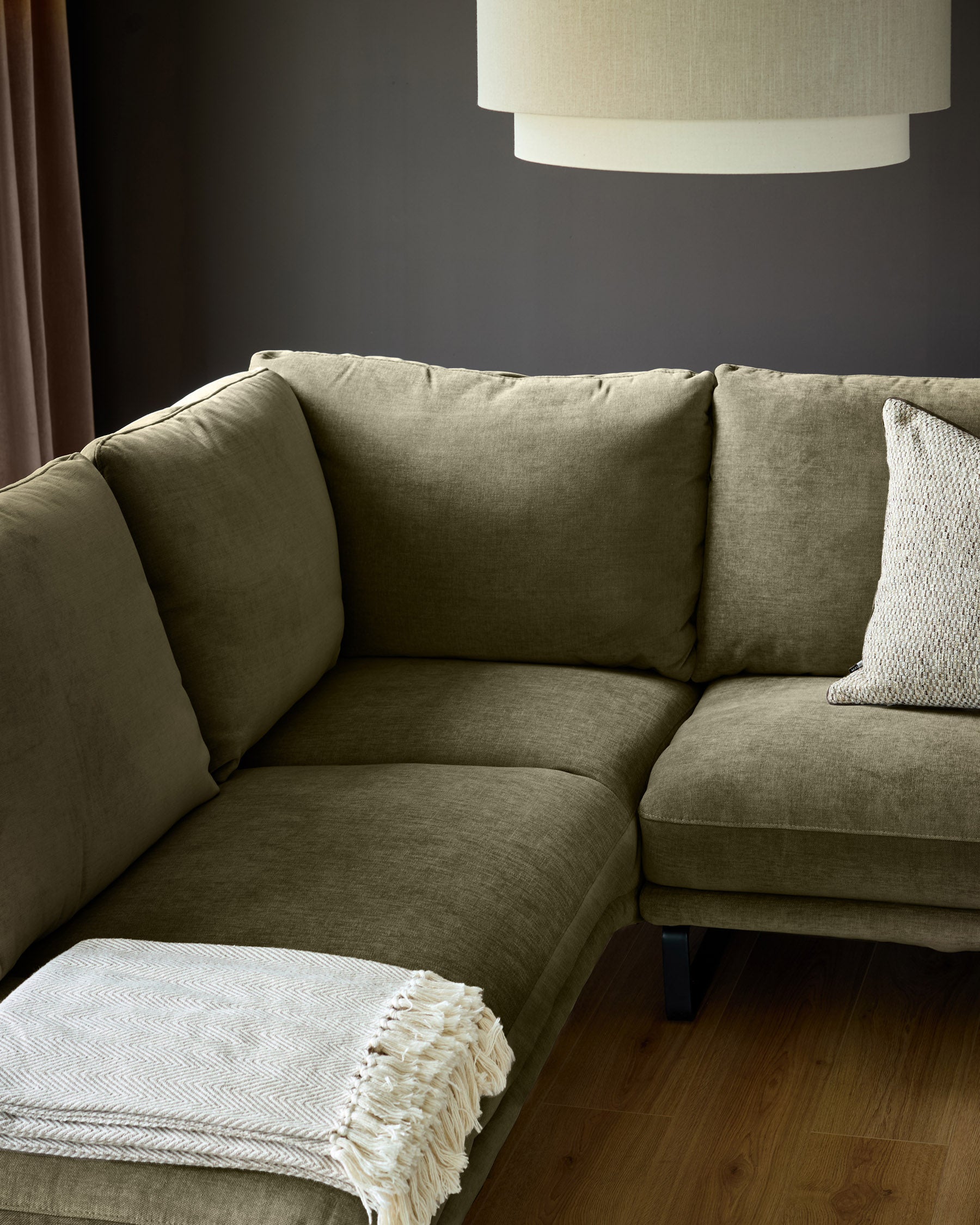 Colette left-hand corner chaise sofa in olive green fabric, shown in a styled living room setting with pendant lamp above.