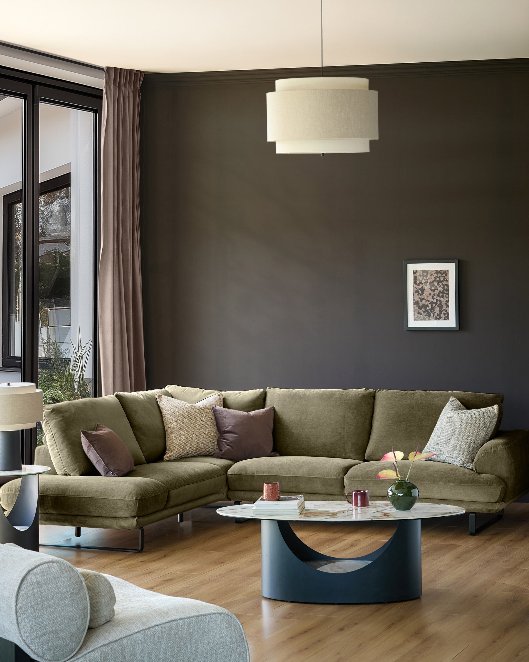 Olive green left-hand corner chaise sofa in a modern living room setting with neutral décor.