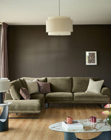 Colette left-hand corner chaise sofa in olive green fabric, displayed in a modern living room setting with coordinating cushions.