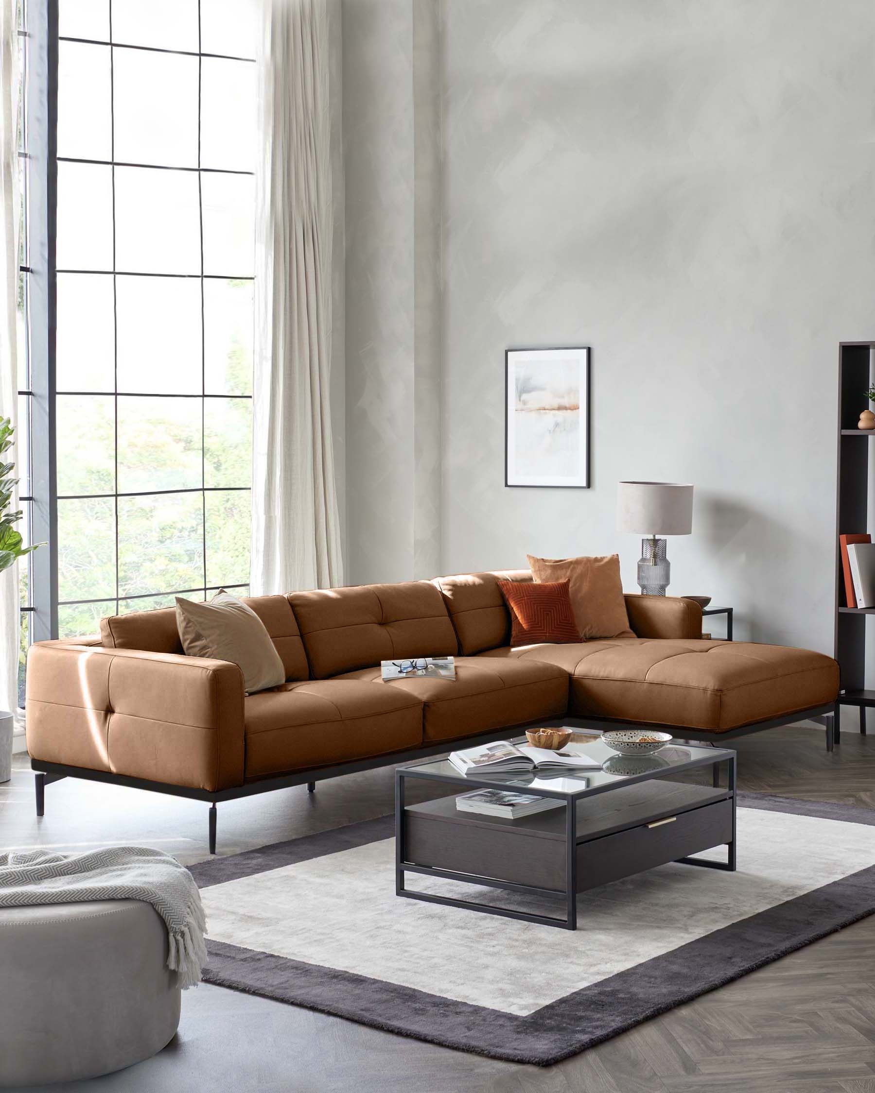 A stylish, tan leather sectional sofa with dark metal legs sits on a patterned rug in a well-lit living room.