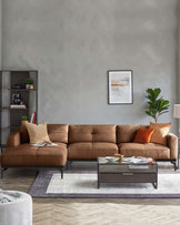 A living room featuring a brown leather sofa, coffee table, ottoman, and a bookshelf. There is artwork on the wall.