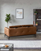 A stylish brown leather sofa with sleek, black metal legs, complemented by a modern bookcase and coffee table.