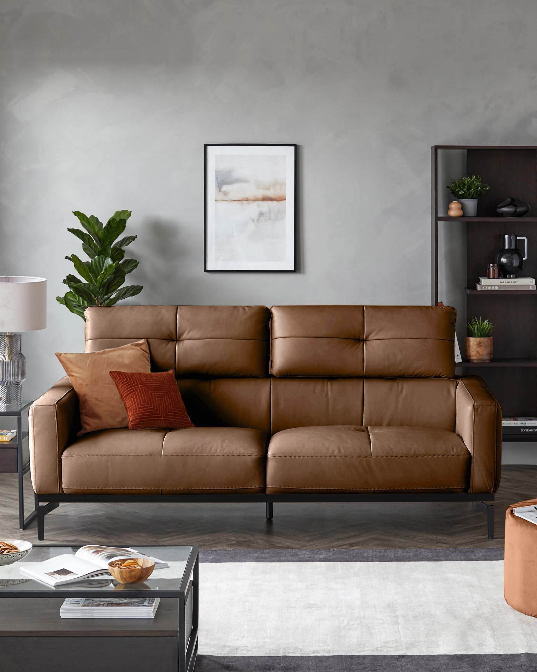 A tan leather sofa with pillows, a dark wood bookcase and coffee table create an inviting living space.