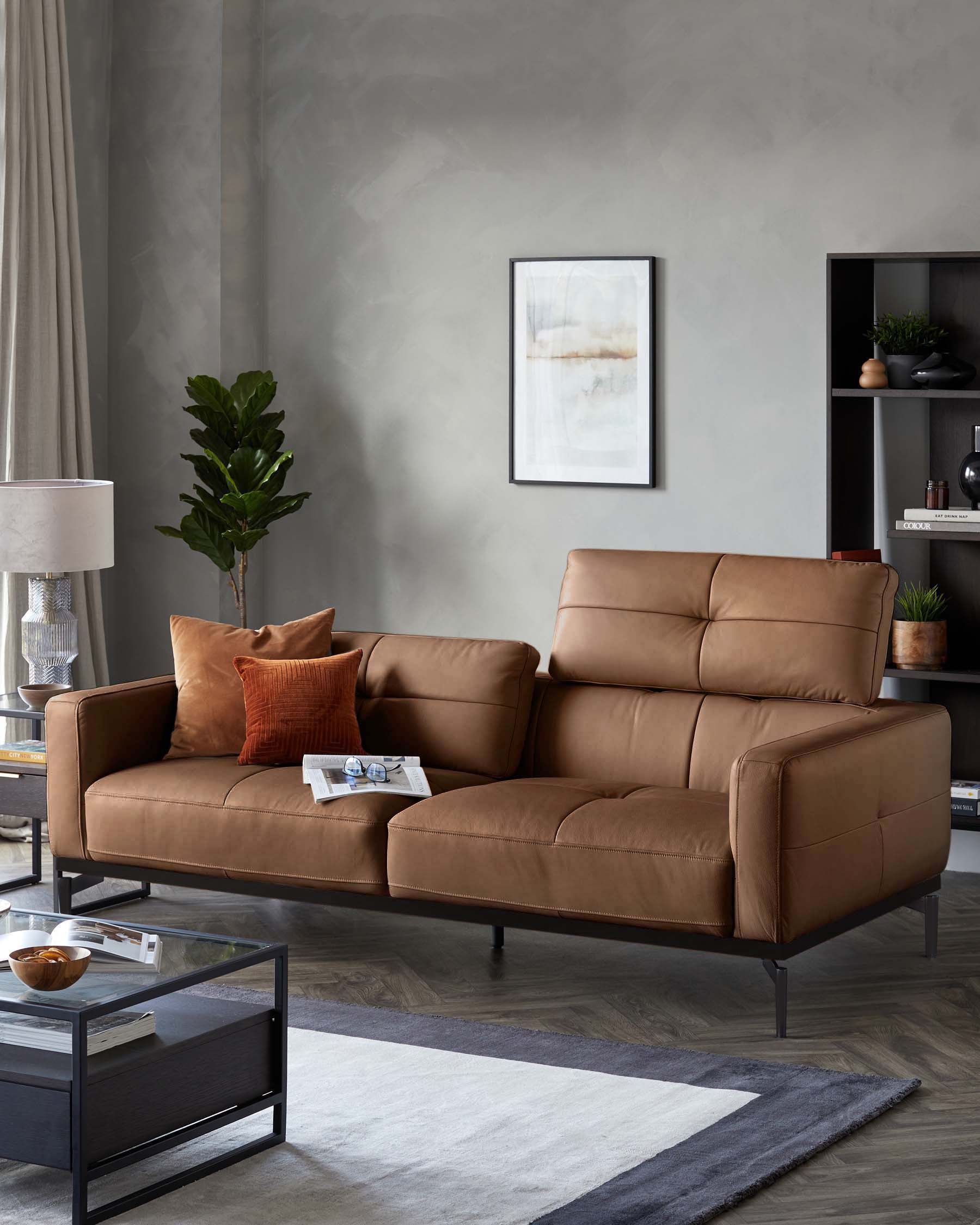 A contemporary leather sofa with a black frame, complemented by a glass coffee table and dark wood shelving.