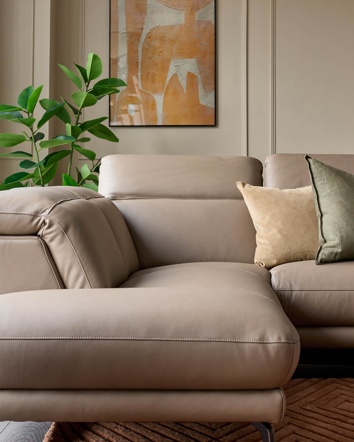 Connor left-hand corner chaise sofa in natural leather, shown with decorative pillows in a styled living room setting.