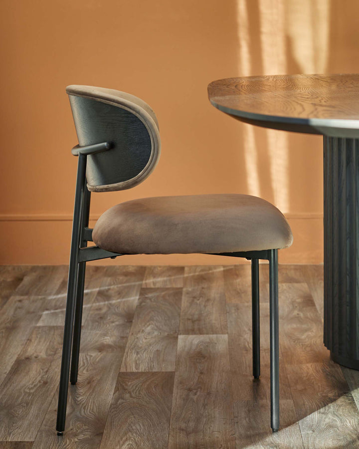 Stylish chair with a curved backrest and a modern dining table, perfect for a contemporary dining space.