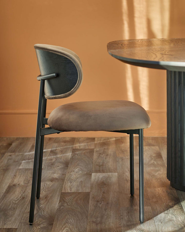 Stylish chair with a curved backrest and a modern dining table, perfect for a contemporary dining space.