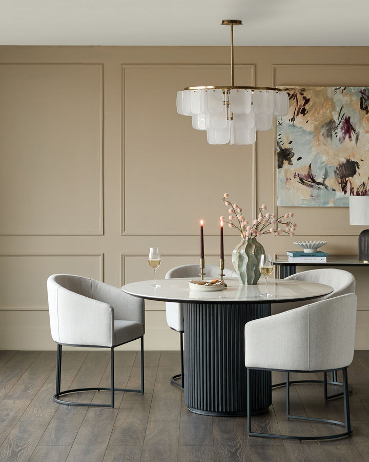Dakota dining chair in natural fabric with black metal frame, shown in modern dining room setting.