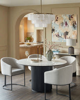 Dakota dining chair in natural fabric, curved backrest design, metal frame base, shown in beige upholstery.