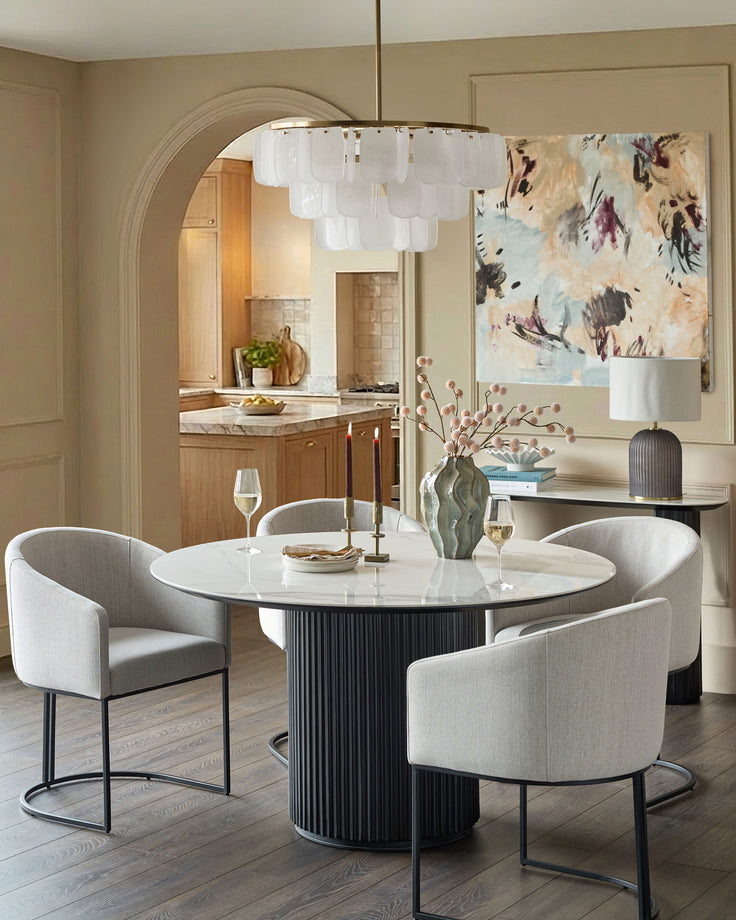 Dakota dining chair in natural fabric, curved backrest design, metal frame base, shown in beige upholstery.