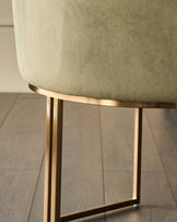 Dakota dining chair in olive green velvet with brushed gold metal base, side view detail.