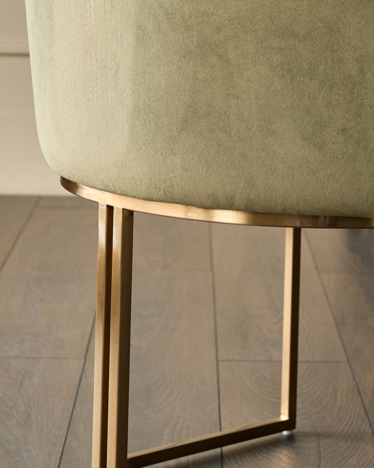 Dakota dining chair in olive green velvet with brushed gold metal base, side view detail.