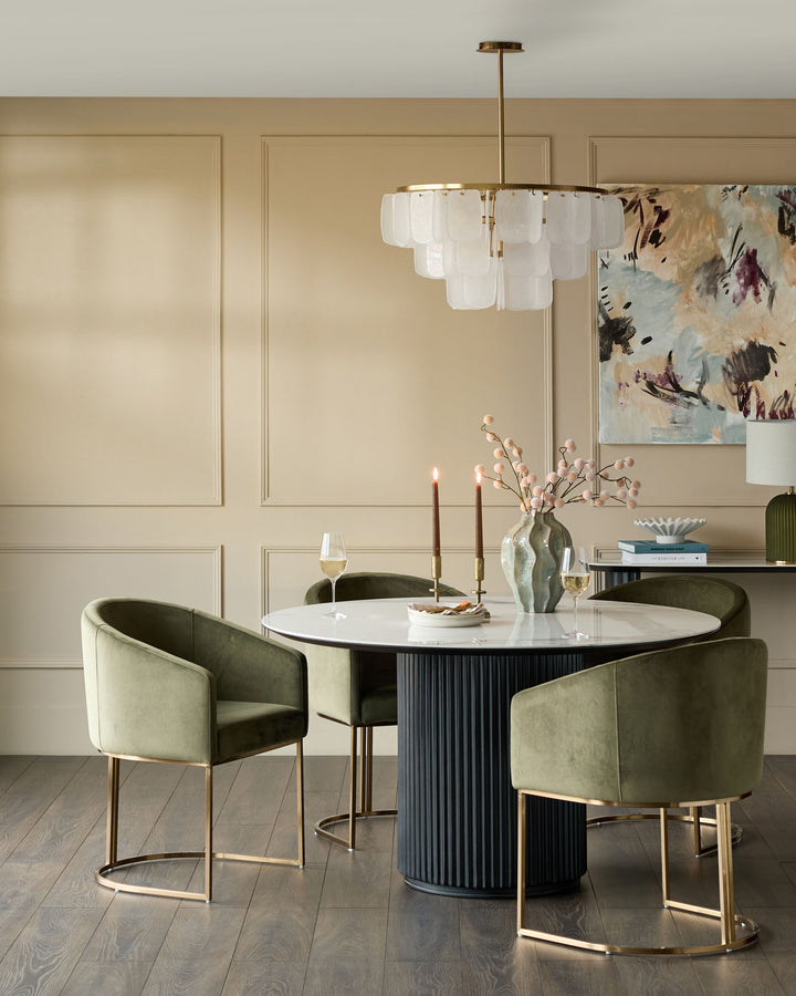 Dakota dining chair in olive green velvet with brass legs, shown in elegant dining room setting.