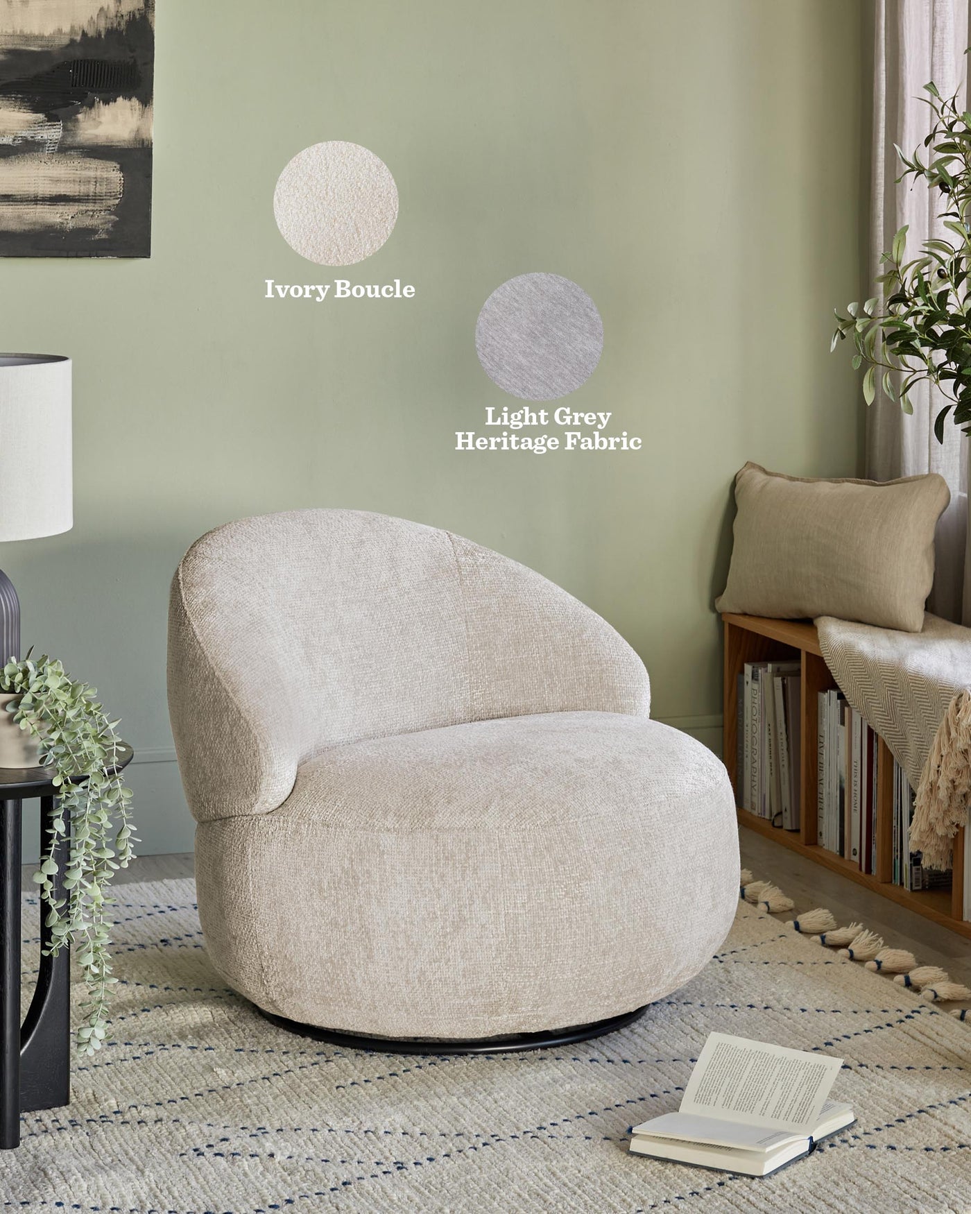 Modern textured fabric swivel chair in ivory boucle, paired with a simple black side table and a neutral toned woven area rug. The room also includes a floor lamp with a white shade and a cosy corner reading nook with books and a cushioned chair with a linen throw pillow.