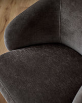Darcy swivel dining chair in mocha fabric, close-up detail showing curved backrest and seat cushion from above.