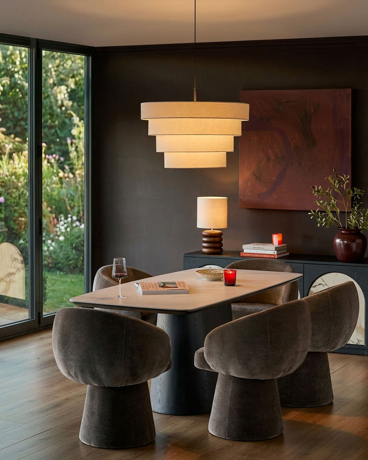 Mocha fabric swivel dining chair with curved mushroom-shaped base, shown in modern dining room setting.