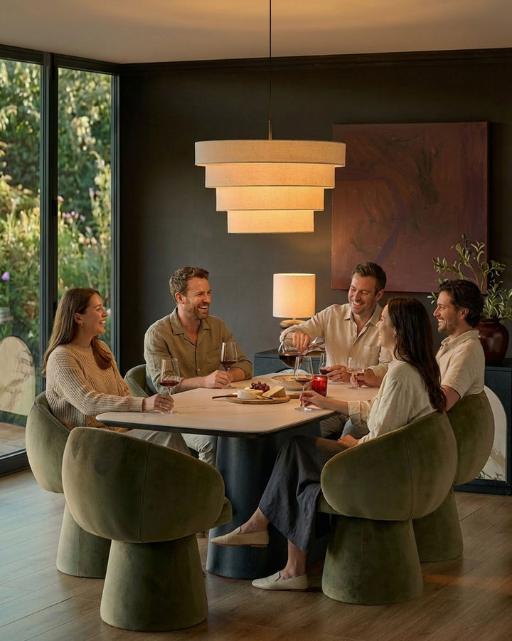 Darcy swivel dining chair in olive green velvet, shown around table in modern dining setting.