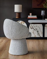 Darcy Swivel Dining Chair in grey fabric, shown from rear angle in a styled dining room setting.