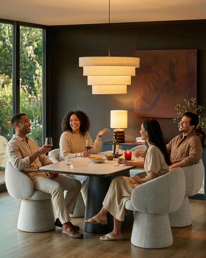 Darcy grey fabric swivel dining chair shown in modern dining setting with four chairs around table.