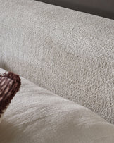 Close-up of natural beige fabric texture on Darla king-size ottoman bed with burgundy piping detail