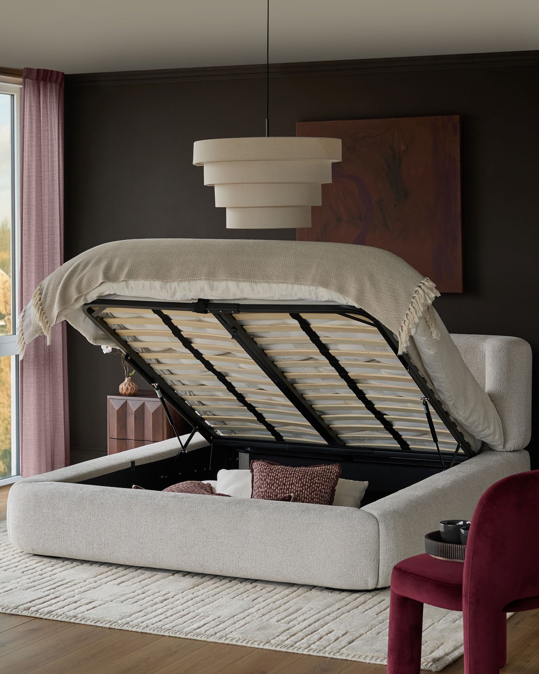 Darla king-size ottoman bed in natural fabric with open storage base, styled in modern bedroom setting.