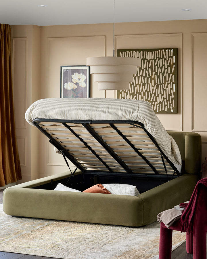 Darla King-Size Ottoman Bed in olive green velvet with storage compartment open, showing black metal frame and slatted base.