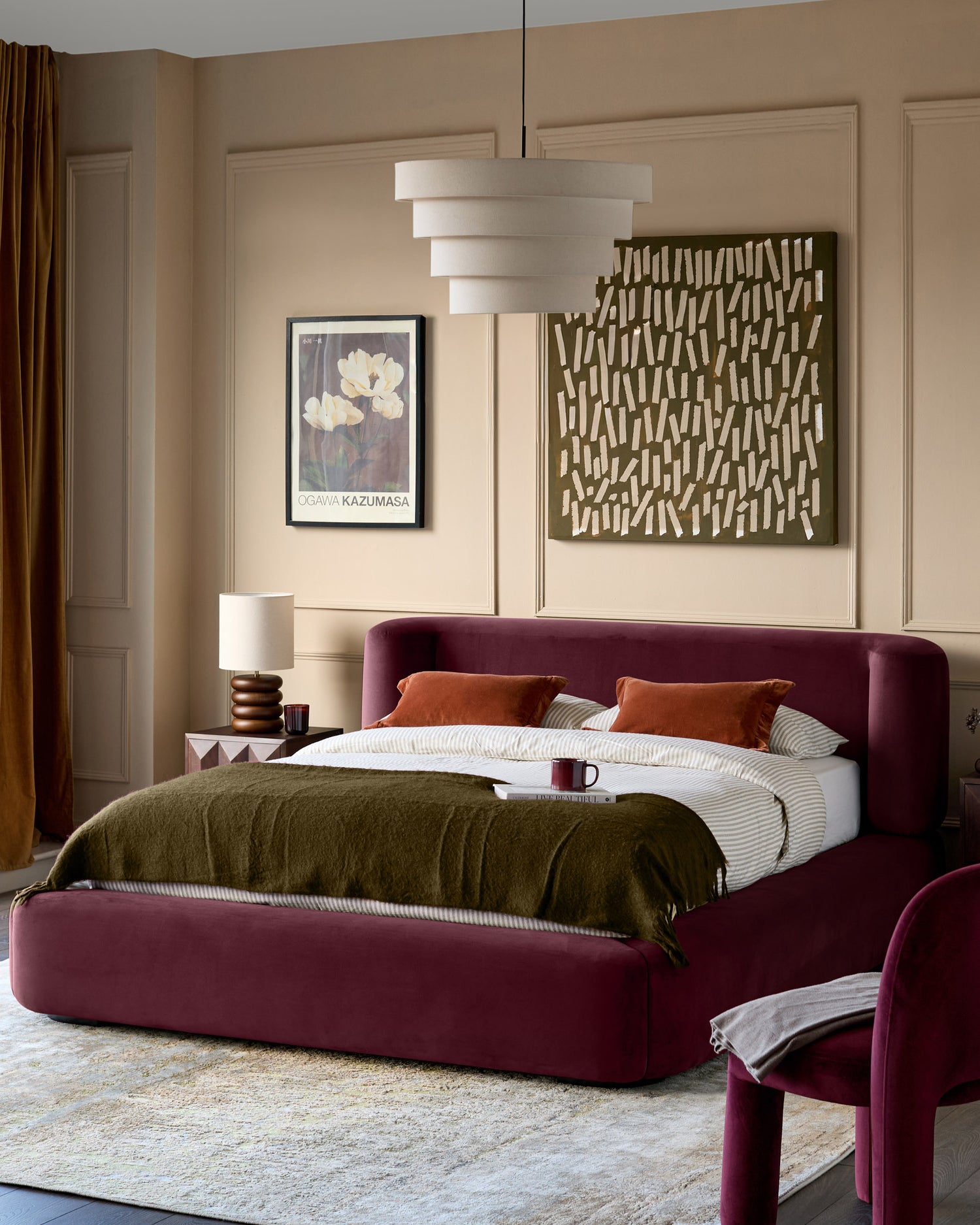 Darla king-size ottoman bed in plum velvet, displayed in a bedroom setting with rounded edges and upholstered design.