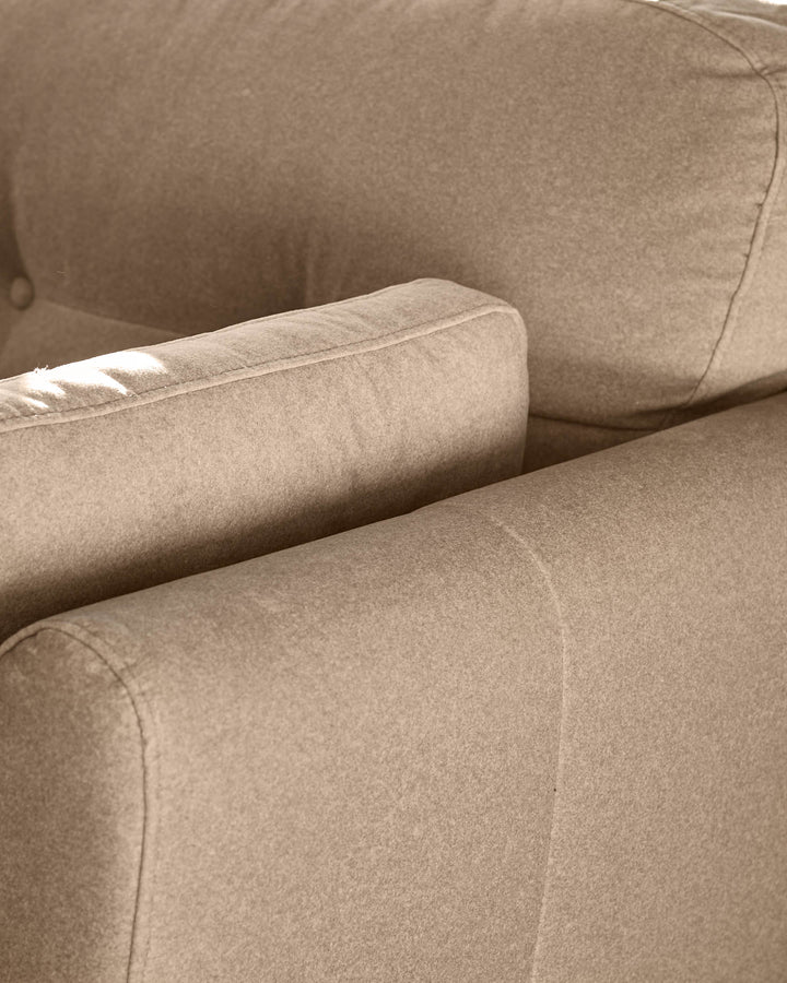 Delilah Armchair in mocha fabric, close-up detail of rolled arm and seaming.