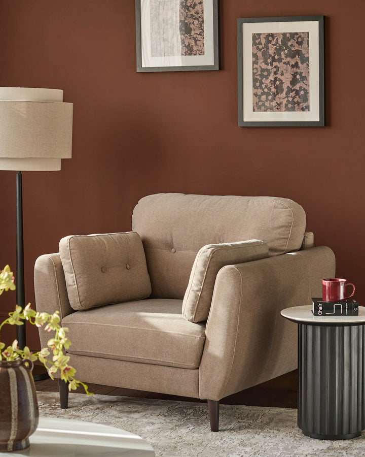 Mocha fabric armchair with rolled arms, button tufting, and tapered legs in a warm rust-colored room setting.