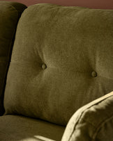 Pistachio green fabric 3-seater sofa with button-tufted backrest, angled detail view.