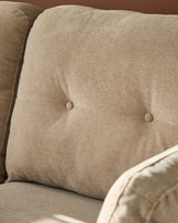 Delilah 3-seater sofa in mocha fabric, close-up of tufted cushion detail with button accents.