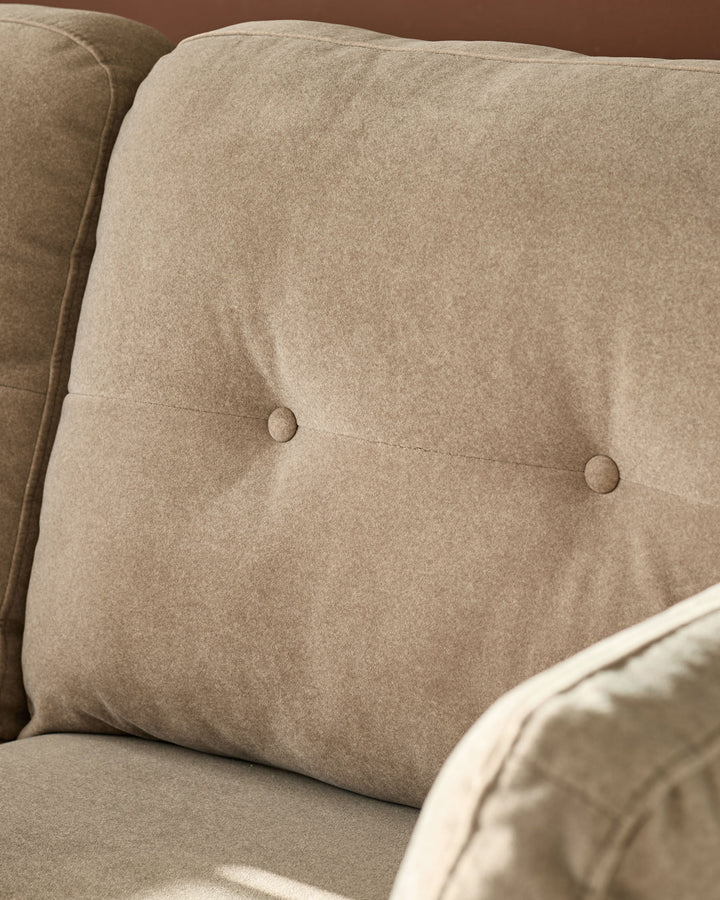 Delilah 3-seater sofa in mocha fabric, close-up of tufted cushion detail with button accents.