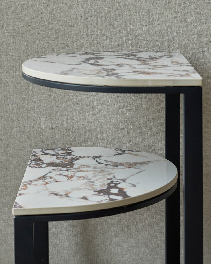 Two-tiered marble effect side table with dark metal frame. Modern design.
