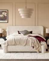 Deven King-Size Ottoman Bed in natural fabric with rounded headboard, displayed in a styled bedroom setting with neutral décor.