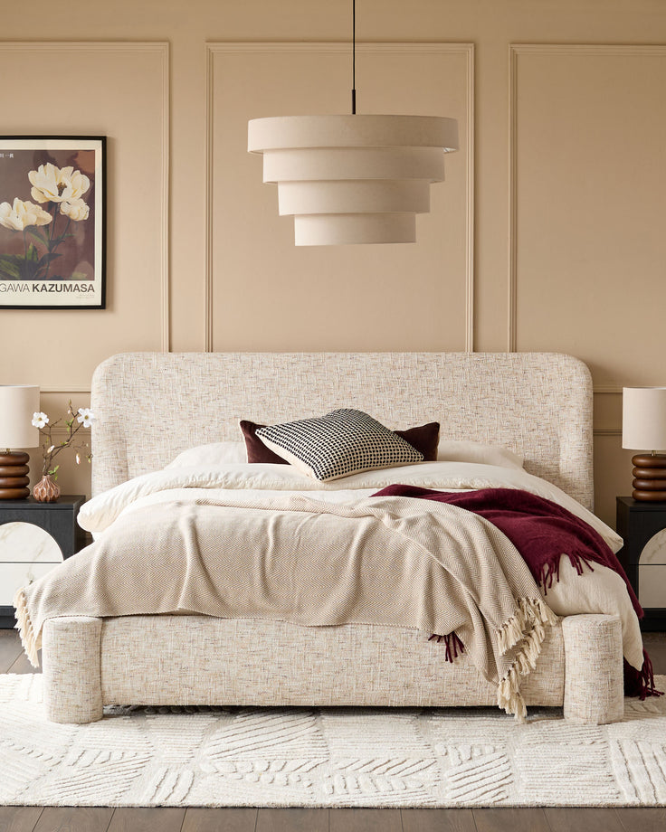Deven King-Size Ottoman Bed in natural fabric with rounded headboard, displayed in a styled bedroom setting with neutral décor.