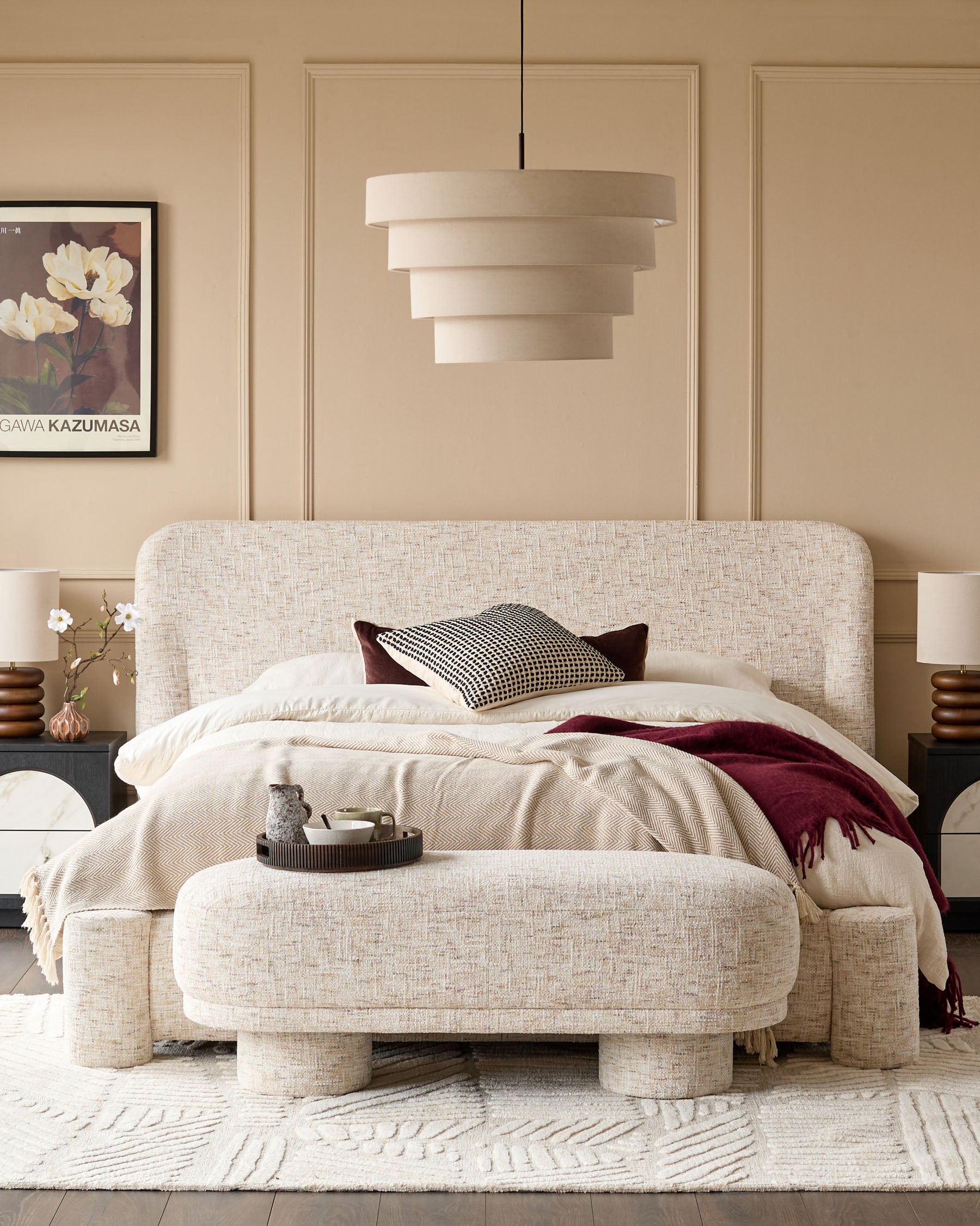 Deven King-Size Ottoman Bed in natural fabric with rounded edges, displayed in a beige bedroom with matching bench.