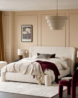 Deven king-size ottoman bed in natural beige fabric, displayed in a styled bedroom setting with neutral décor.