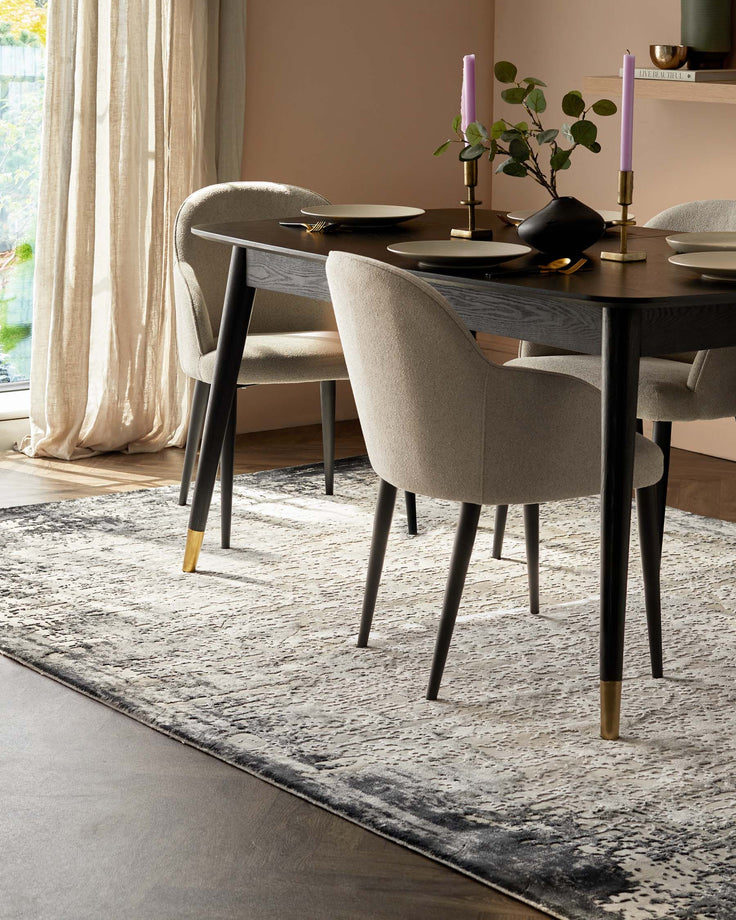 A contemporary dining set with a dark wood table and upholstered chairs sits atop a patterned rug, creating an inviting space.
