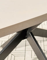 Close-up of concrete tabletop and dark grey metal frame of garden dining table