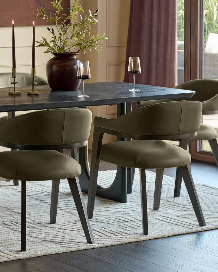 Dylan dining chair in olive green leather, shown at dark dining table with candles and floral centerpiece.