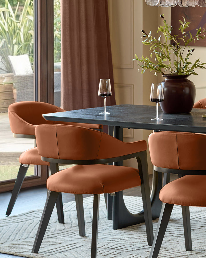 Dylan dining chair in tan leather, shown at a dark dining table with black wine glasses and floral arrangement.