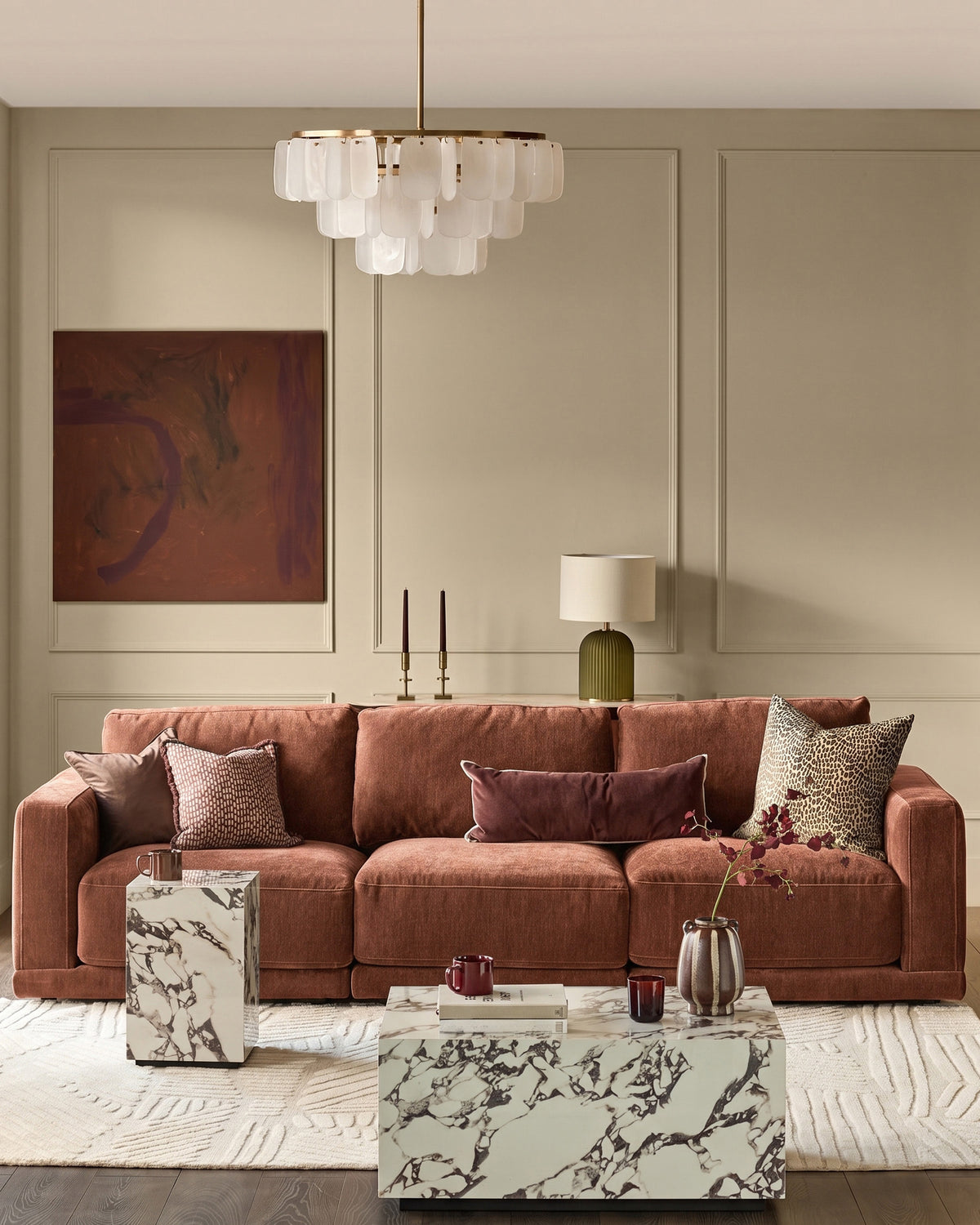 Eden 3-seater sofa in apricot fabric, styled in a modern living room with decorative pillows and marble coffee table.