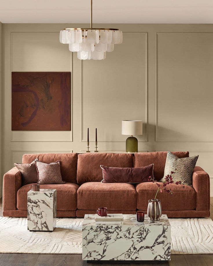 Eden 3-seater sofa in apricot fabric, styled in a modern living room with decorative pillows and marble coffee table.