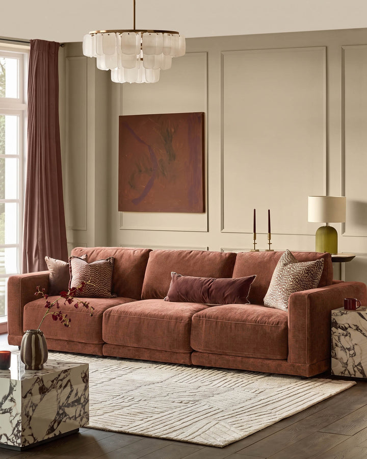Eden 3-seater sofa in apricot fabric, displayed in a styled living room with decorative pillows and neutral decor.