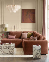 Eden left large chaise sofa in apricot fabric, displayed in a styled living room setting with coordinating pillows and decor.
