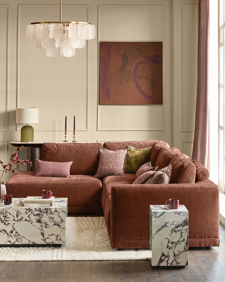 Eden left large chaise sofa in apricot fabric, displayed in a styled living room setting with coordinating pillows and decor.