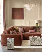 Apricot fabric right-facing large chaise sectional sofa styled in a contemporary living room with decorative pillows.