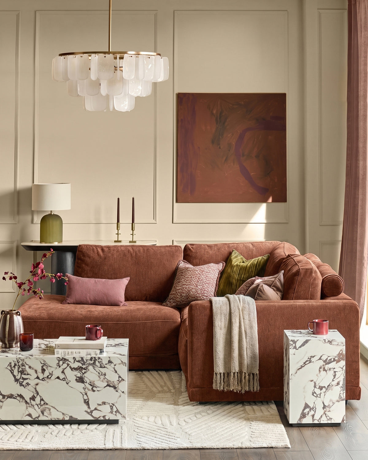 Eden Left Small Chaise Sofa in apricot fabric, displayed in a styled living room setting with coordinating pillows and throws.