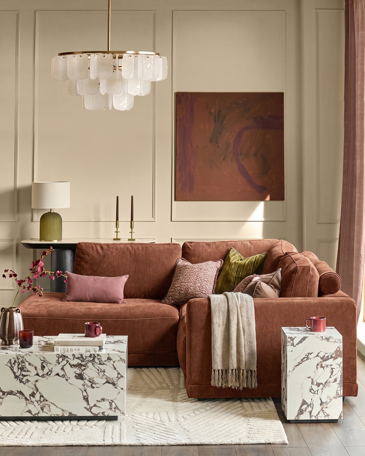 Eden Left Small Chaise Sofa in apricot fabric, displayed in a styled living room setting with coordinating pillows and throws.
