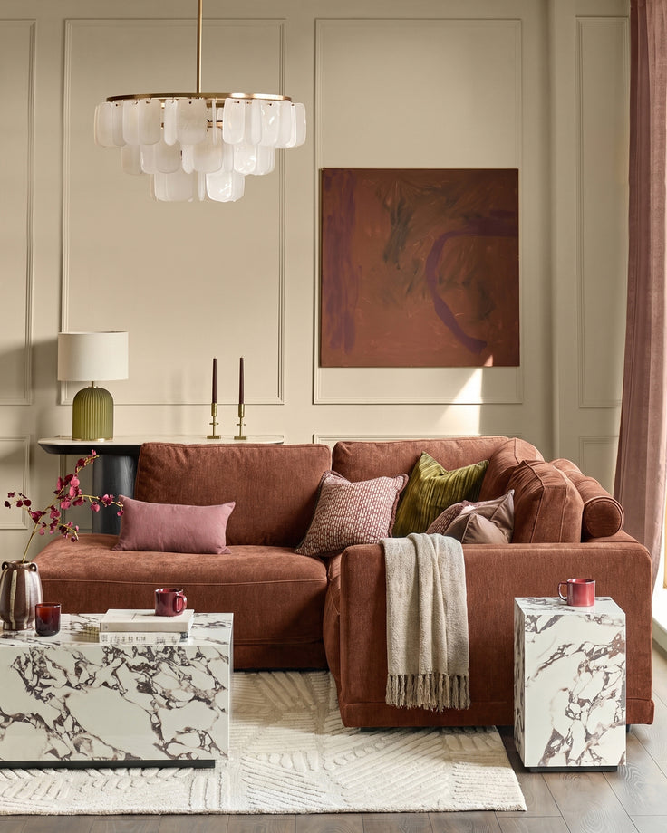 Eden Left Small Chaise Sofa in apricot fabric, displayed in a styled living room setting with coordinating pillows and throws.